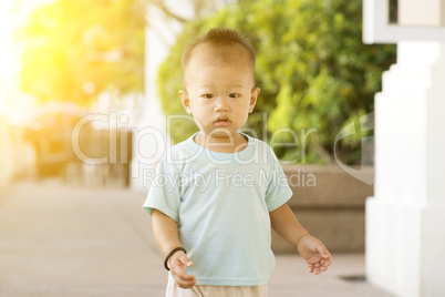 Asian toddler walking at outdoor