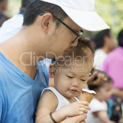 Father and son eating ice creams