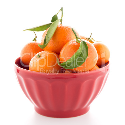 Tangerines on ceramic red bowl