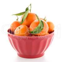 Tangerines on ceramic red bowl