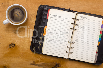 Open diary on wooden table