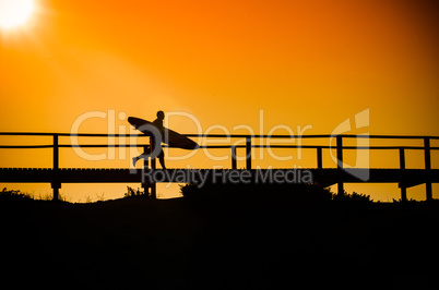 Surfer running to the beach