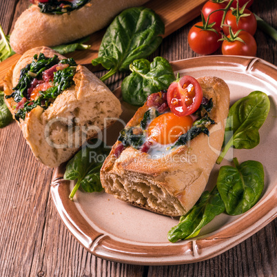 farmer baguette filled with egg, bacon and spinach