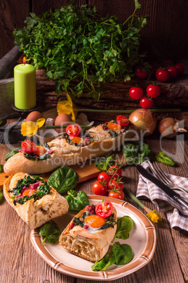 farmer baguette filled with egg, bacon and spinach