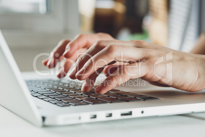 woman's hands working on laptop computer