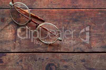 Old Spectacles On Wood