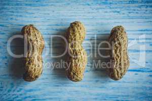 Fresh peanuts in shell on blue desk