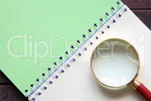 Magnifying Glass On Notebook