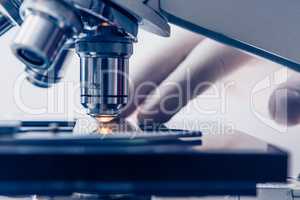 Scientist hands with microscope