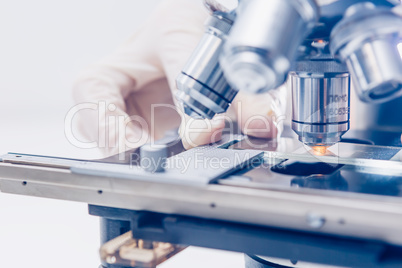 Scientist hands with microscope