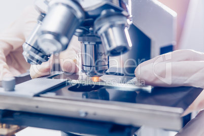 Scientist hands with microscope