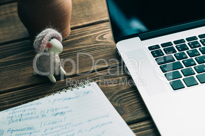 Workplace with open laptop on modern wooden desk