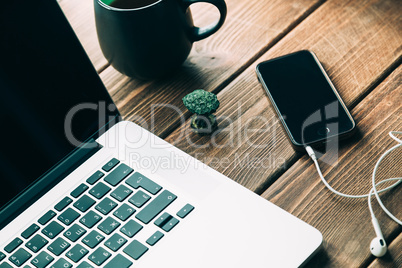 Workplace with open laptop on modern wooden desk