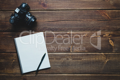 notebook and vintage camera on the desk