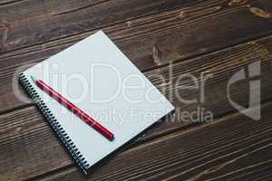 notebook with pen and coffee  on old  wooden table