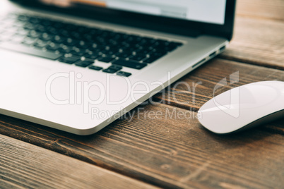 Workplace with open laptop on modern wooden desk