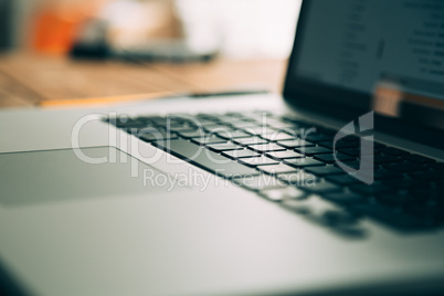 Workplace with open laptop on modern wooden desk