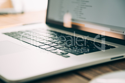 Workplace with open laptop on modern wooden desk