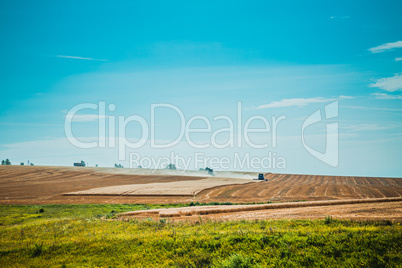 combine harvester on wheat field with  blue sky