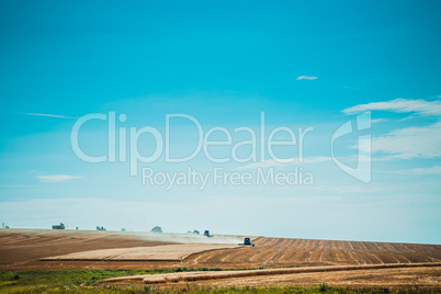 combine harvester on wheat field with  blue sky