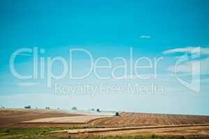 combine harvester on wheat field with  blue sky