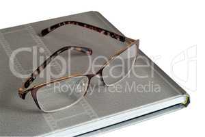 Glasses and notebook on a white background.