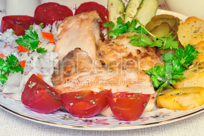 Baked fish and vegetables .