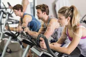 Fit people doing exercise bike