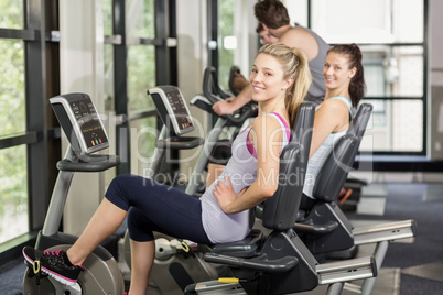 Fit people doing exercise bike