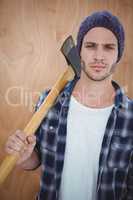 Handsome hipster holding an axe