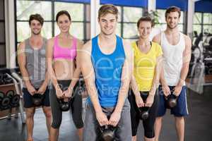 Fitness class lifting dumbbells