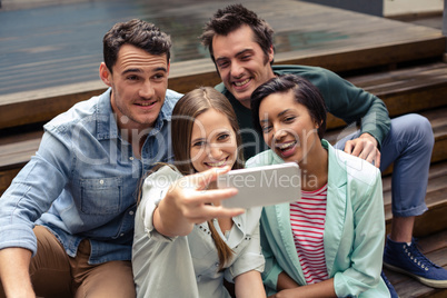 Happy friends taking selfie