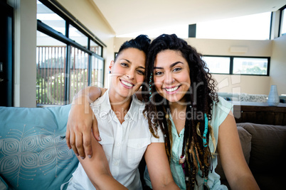 Portrait of happy lesbian couple embracing each other and smilin