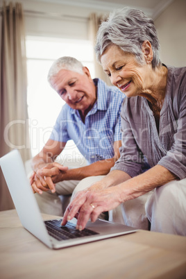 Senior woman using laptop in living room