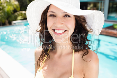 Beautiful woman smiling near poolside