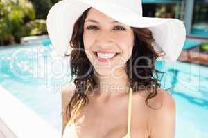 Beautiful woman smiling near poolside