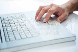 Close up view of a male hand using laptop