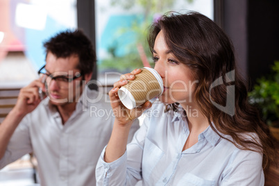 People using smartphone and drinking coffee