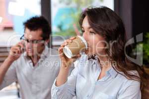 People using smartphone and drinking coffee