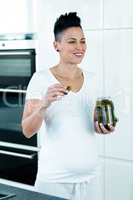 Pregnant woman eating pickles