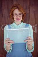Red haired hipster using tablet