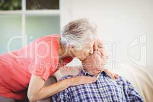 Senior woman kissing man on cheek
