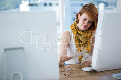 thoughtful hipster woman looking at colour swatches