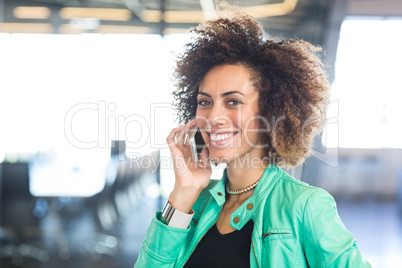 Young woman using mobile phone in office