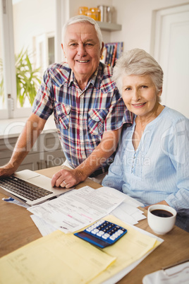 Portrait of senior couple checking their bills