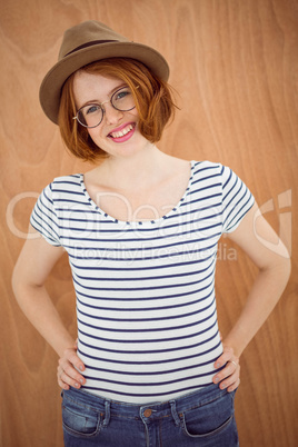 smiling hipster woman with her hands on her hips