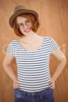 smiling hipster woman with her hands on her hips