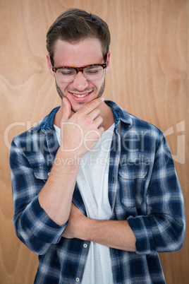 Handsome hipster with glasses with hand on chin