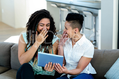 Lesbian couple using digital tablet