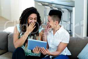 Lesbian couple using digital tablet